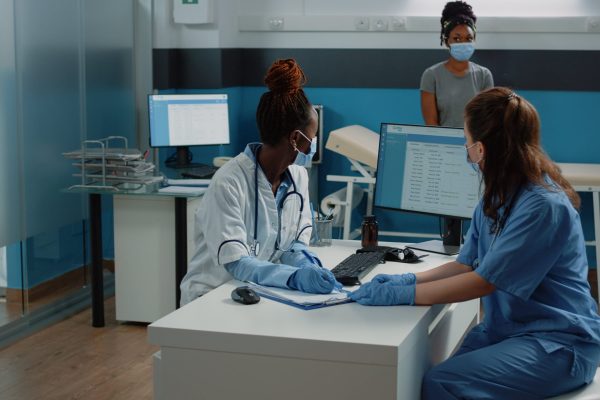 doctor-nurse-working-with-prescription-document-patient-checkup-healthcare-medic-writing-medical-paper-consultation-treatment-cure-woman-with-disease-cabinet-min